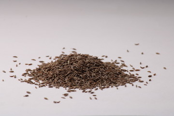 Pile of cumin seeds isolated on white background
