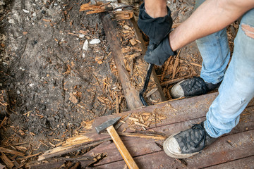 Deconstrution of old wooden floor in old house, exposed log under planks