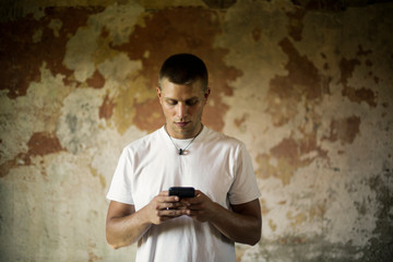 Blonde guy in a ruined place