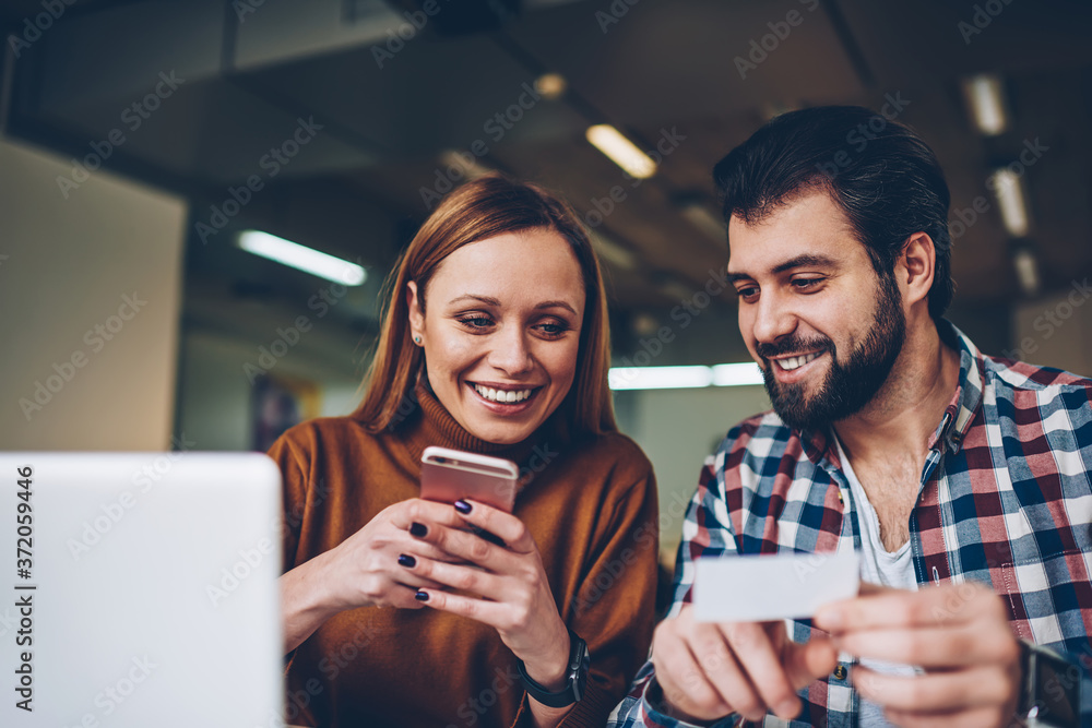 Poster attractive smiling hipster girl typing funny joke from paper gived positive male friend in social ne