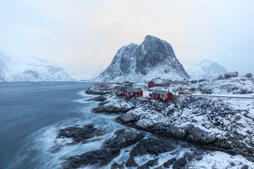 Beautiful traditional fishing red rorbuer huts in Hamnoy village during a storm. Lofoten Islands, Norway, Scandinavia.