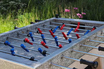 Table football stands outdoors. Foosball table stands at the public place.