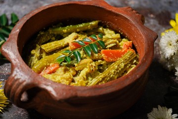Aviyal - Kerala mixed vegetable curry with coconut and veggies, selective focus
