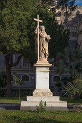 Fototapeta na wymiar View of the 18th century statue of Saint Agatha, holding a book and a cross in front of the Catania Cathedral in Catania, Sicily, Italy