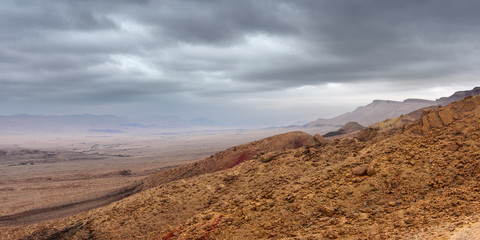 Low dark clouds over a deserted mountain canyon, multi-shot panorama.