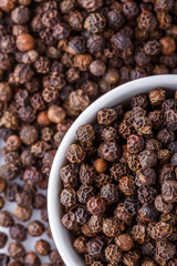 fragrant black pepper on white acrylic background