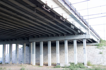 Fototapeta na wymiar Supports of the road bridge over the railway tracks