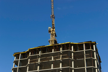 
Reinforced concrete structure of a building under construction and a construction crane