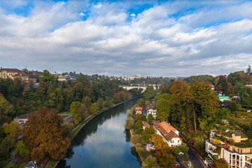 Beautiful view of Aare river in Bern from Kornhausbrücke (Kornhaus bridge) with  Lorrainebrücke (Lorraine bridge) and railway viaduct in background, on sunny autumn day, Switzerland