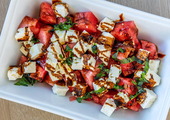 Watermelon salad with feta cheese and a drizzle of balsamic vinegar 