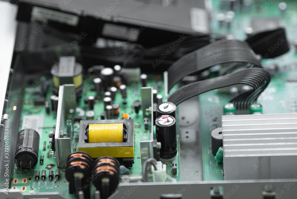 Poster a close-up microchip with many electrical components placed on the board. the background is blurred.