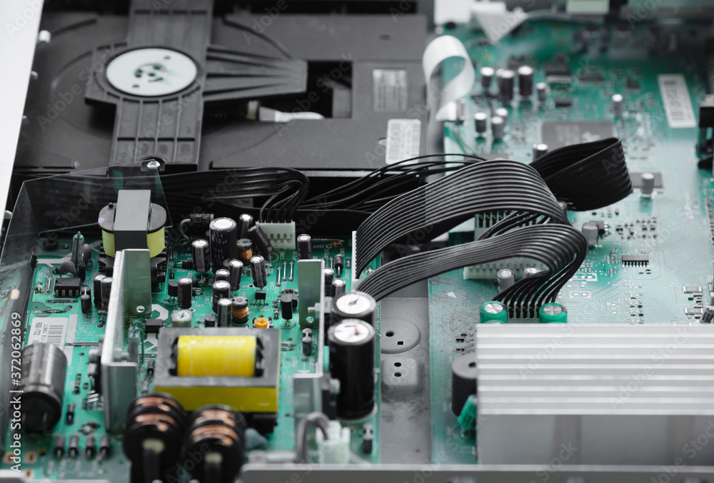 Aufkleber a close-up microchip with many electrical components placed on the board. the background is blurred.