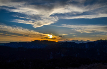 Panoramic view of the mountain landscape at sunset. Mountain silhouettes. View from Mount Tahtali near Kemer to Taurus Mountains, Turkey