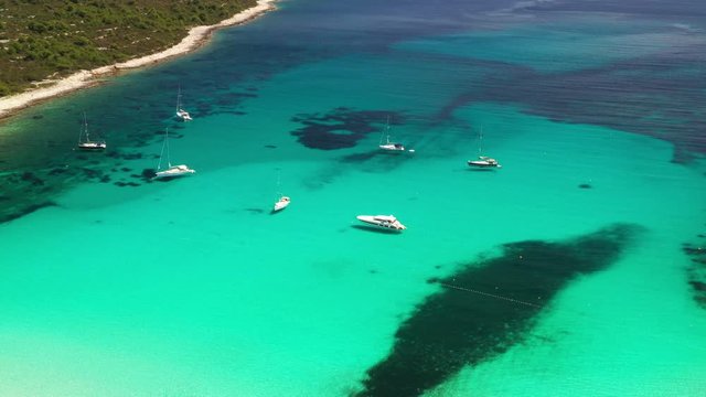 Amazing Adriatic coast in Croatia. Yachts and sailboats in turquoise lagoon on Sakarun beach on Dugi Otok island.