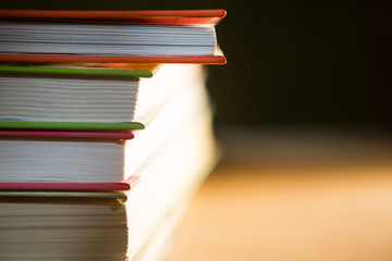 Close-up of a stack of books. The concept of home reading of paper books, school education and Institute, back to school. Space for text, background.