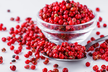 fragrant pink peppercorns on white acrylic background