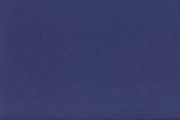 The texture of the knitted fabric is dark blue. Solid bright blue background.