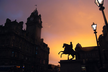 Edinburgh streets at sunset with a statue in the front