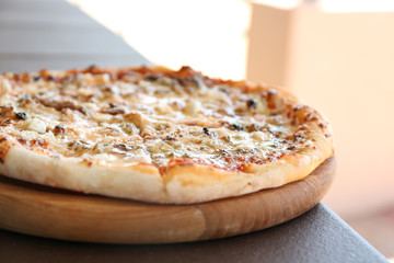 Delicious fresh pizza on table outdoors, closeup