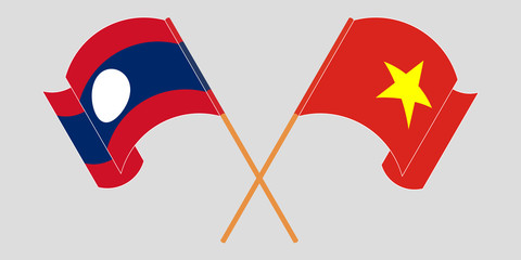 Crossed and waving flags of Laos and Vietnam