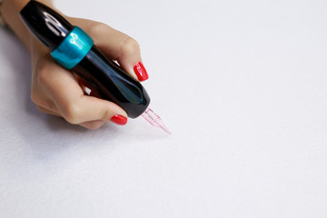 Pencil for permanent makeup in female hand. Brows tattooing. Microblading brow. Free space for...