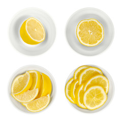 Lemons in white glass bowls. Freshly cut lemon halves, wedges and slices. Ripe and yellow citrus fruits, used for culinary purposes. Citrus limon. Close up from above, isolated over white, food photo.