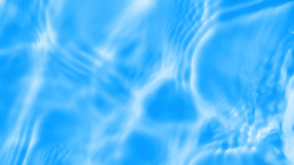 Photo of water waves shadow on pool bottom. Subtle texture of light-shadow pattern of sunlight reflection from rippled water surface. Beautiful natural wallpaper.