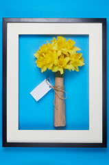 Bouquet of yellow spring flowers. Bunch narcissus packed craft paper with greeting card.Spring card for Mother's Day