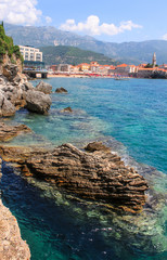 Mogren Beach Budva in Montenegro. Relaxing on the nature. Tourism in Europe, ocean and sea vacations. Big rocks in the middle of the sea or ocean with great blue raging water waves breaking on a stone