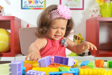 Fototapeta na wymiar Portrait of little baby girl with toys