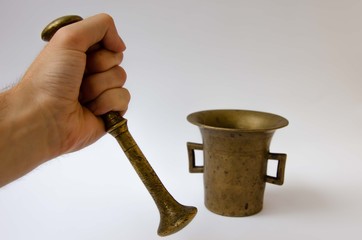 Bronze mortar hand. Cooking in a mortar. Mortar and pestle white background.