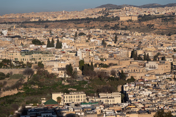 Obraz premium Fes Morocco cityscape with medina in centre seen from hills above in bright sun 
