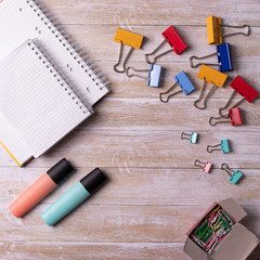 different stationary items on wooden desk