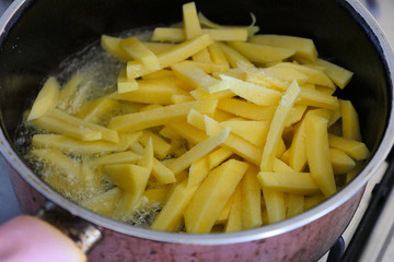 sliced potatoes fried in the pan French fries for breakfast in the morning