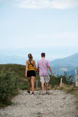 Obraz na płótnie Canvas Portrait on back view of couple walking in the mountain way