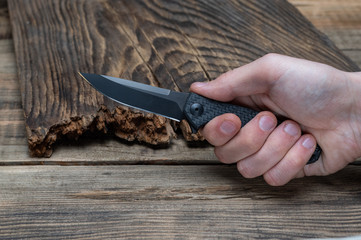 Knife clamped in hand. Hit with a knife. Stab with a knife.