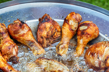 Chicken thigh and drumstick frying in hot oil dish plate