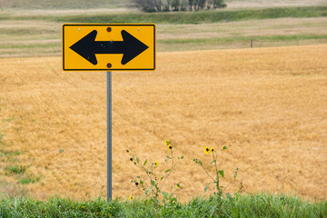 road sign on a green field