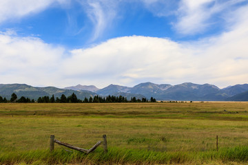 Fenced field with mountains behind (landscape)