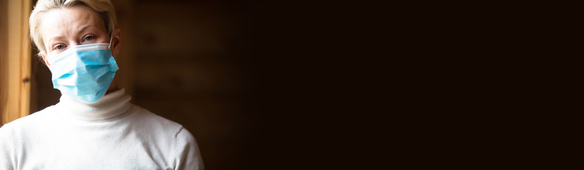 Studio portrait of young woman wearing a face mask, looking at camera.