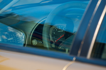 Obraz na płótnie Canvas Driving Wheel and dashboard thru the car window.