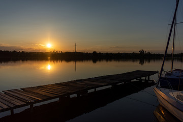 Summer sunset over a calm lake.