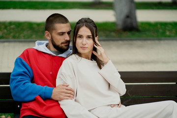 young couple sitting on bench