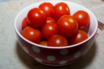 the cherry tomatoes in a red Cup with white polka dots