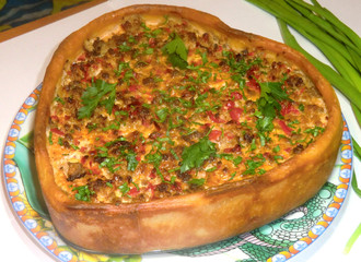 Festive homemade pie with meat, vegetables and fresh herbs