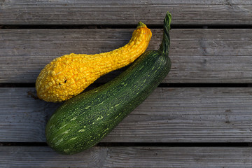 Fresh long yellow pumpkin and zucchini on wooden background.  Agriculture concept.