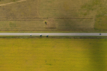 Naklejka premium Rural road between agriculture fields. Aerial view.