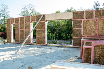 Construction of a house from an environmentally friendly material of plant origin. Frame made of wood, blocks of straw.