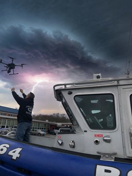 Pilot Grabbing Drone From Police Boat