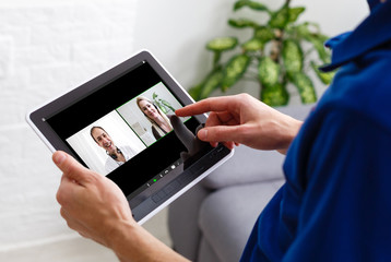 Man having video conference with friends on laptop at home